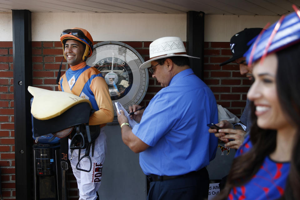 A jockey is weighed in the winner's circle following the day's seventh race at Pimlico Race Course, Saturday, May 18, 2019, ahead of the Preakness Stakes horse race in Baltimore. (AP Photo/Patrick Semansky)