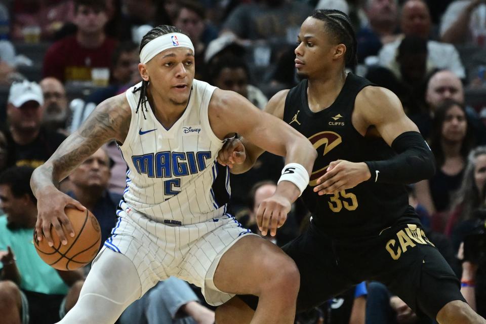 Cavaliers forward Isaac Okoro defends Magic forward Paolo Banchero during the second half in Game 5 of a first-round NBA playoff series, April 30, 2024, in Cleveland.