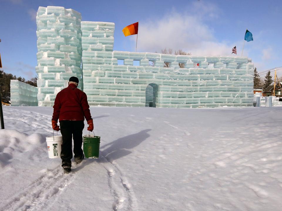 Dean Baker carries buckets loaded with water and ice for the construction of the Hotel Saranac ice palace in Saranac Lake, N.Y. in a file photo. Built completely by volunteers, the ice palace is one of the annual attractions of the Saranac Lake Winter Carnival.
(Photo: Mel Evans, AP)