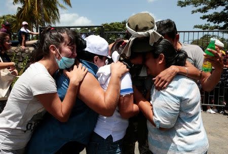 Relatives embrace an university student who was freed after being trapped overnight in Divine Mercy Catholic Church where they took shelter as pro-government gunmen shot at them at the National Autonomous University of Nicaragua (UNAN), in Managua, Nicaragua July 14, 2018. REUTERS/Oswaldo Rivas