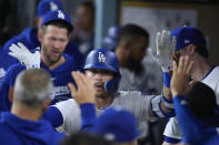 Los Angeles Dodgers' Kiké Hernández celebrates with teammates after hitting a solo home run against the Washington Nationals during the fifth inning of a baseball game Tuesday, April 16, 2024, in Los Angeles. (AP Photo/Marcio Jose Sanchez)