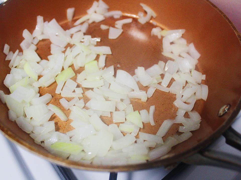 chopped white onions sauteed in pan