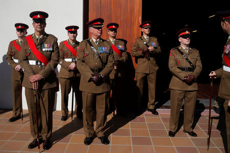 Members of the Royal Gibraltar Regiment stand during the 21-gun salute to mark the 67th anniversary of Britain's Queen Elizabeth's accession to the throne, in front of the Rock in the British overseas territory of Gibraltar, historically claimed by Spain February 6, 2019. REUTERS/Jon Nazca