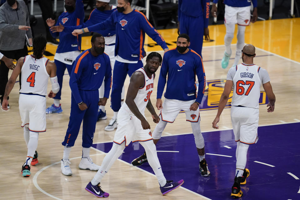 New York Knicks forward Julius Randle (30) celebrates with teammates after scoring during the fourth quarter of an NBA basketball game against the Los Angeles Lakers Tuesday, May 11, 2021, in Los Angeles. The Lakers won 101-99 in overtime. (AP Photo/Ashley Landis)