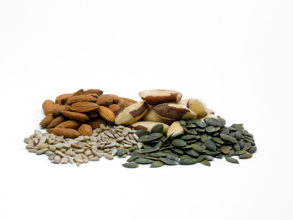 almonds, sunflower seeds, nuts and pumpkin seeds on a white background.