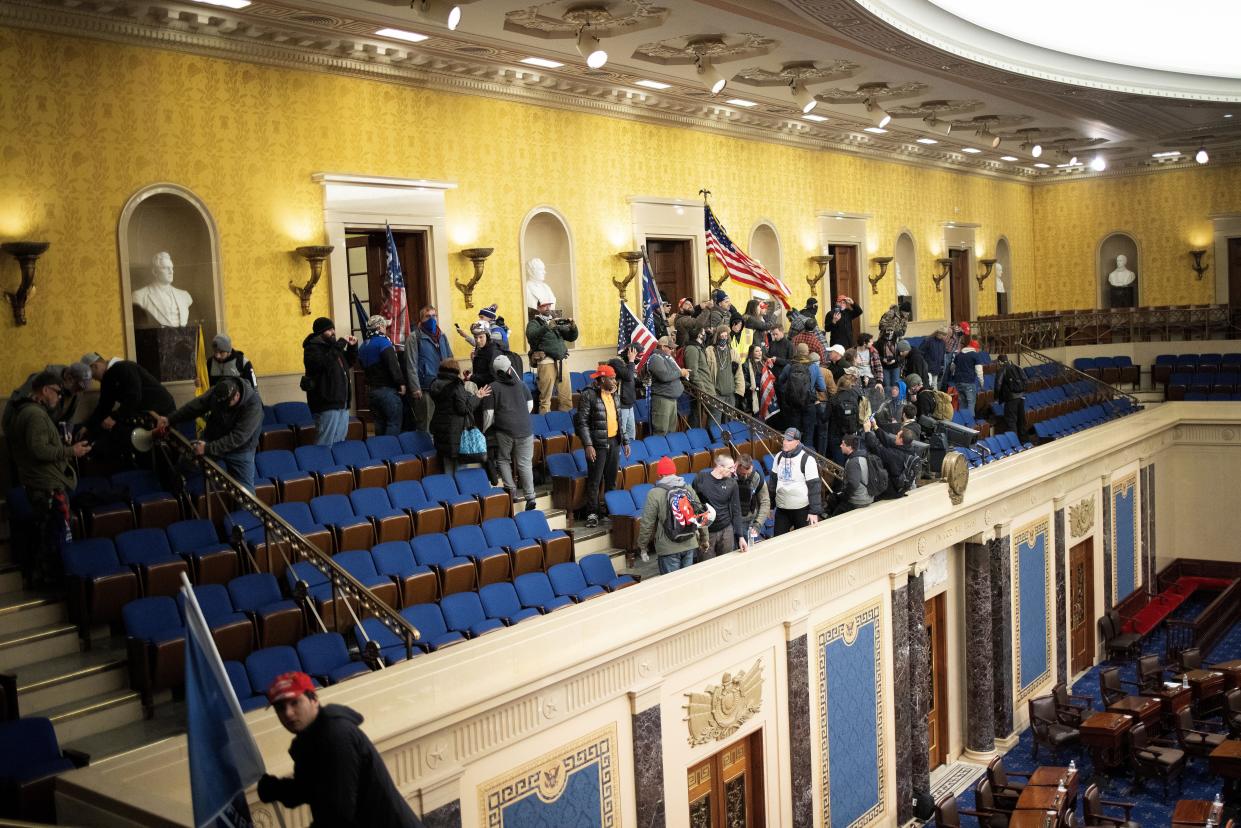 A pro-Trump mob gathers inside the Senate chamber in the U.S. Capitol after groups stormed the building on January 06, 2021, in Washington, DC.