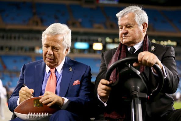CHARLOTTE, NC - NOVEMBER 18:  (L-R) Chairman and CEO Robert Kraft of the New England Patriots signs a football as he sits with owner/founder Jerry Richardson of the Carolina Panthers before the Patriots take on the Panters at Bank of America Stadium on November 18, 2013 in Charlotte, North Carolina.  (Photo by Streeter Lecka/Getty Images)