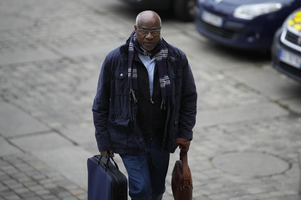 Sosthene Munyemana, a Rwandan doctor arrives at Paris court house, Thursday, Nov. 23, 2023 over his alleged role in the 1994 genocide in his home country. Munyemana who has been living in France for decades faces charges of genocide, crimes against humanity and complicity in such crimes. (AP Photo/Christophe Ena)
