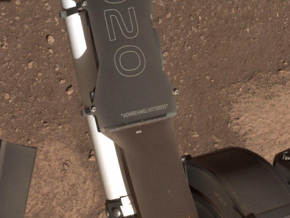 Running vertically along the right side of the mission nameplate is a string of 17 letters and numbers. These characters form a unique product identification number, encoding information about the vehicle's characteristics and manufacture. / Credit: NASA/JPL-Caltech