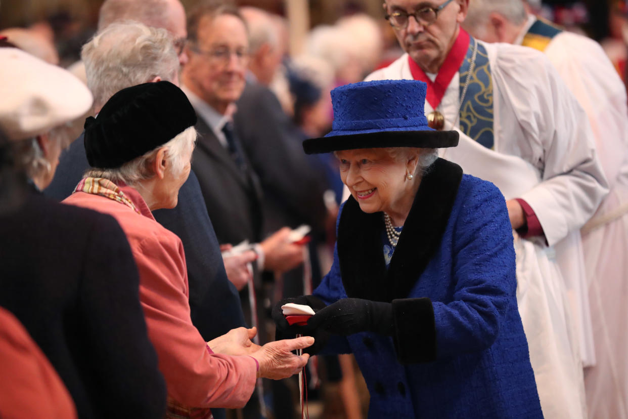 WINDSOR, ENGLAND - MARCH 29: Queen Elizabeth II distributes the traditional Maundy money during the Royal Maundy service at St George's Chapel on March 29, 2018 in Windsor, England. The Queen distributes the Maundy money to 92 men and 92 women, as she will be 92 this year, with each recipient receiving two purses, one red and one white. (Photo by Steve Parsons - WPA Pool/Getty Images)