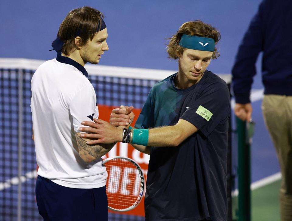 Rublev shakes hands with Bublik after being disqualified (REUTERS)