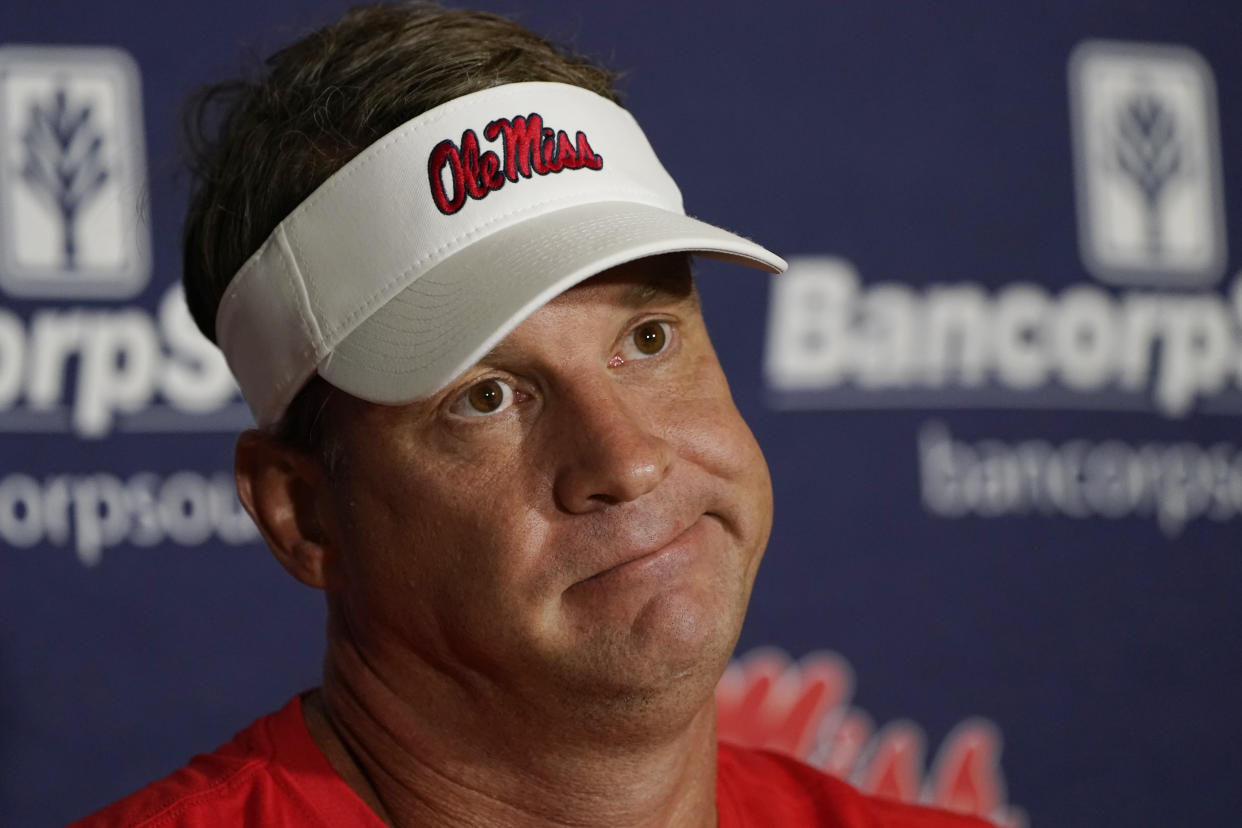 Mississippi coach Lane Kiffin ponders a reporter's question during a news conference before the college football season. (AP Photo/Rogelio V. Solis)