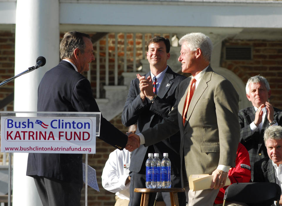 FILE - Former Presidents George H.W. Bush, left, and Bill Clinton shake hands on May 12, 2006, at the Kingsley House in New Orleans where they announced several grants from the Bush-Clinton Katrina Fund totalling $9.7 million. The social services nonprofit, may be best known as the Kingsley House, has dropped the name of a Victorian clergyman Tuesday, Sept. 27, 2022, who is best remembered today as the author of a children's fantasy novel but held profoundly racist views. (AP Photo/Cheryl Gerber, File)