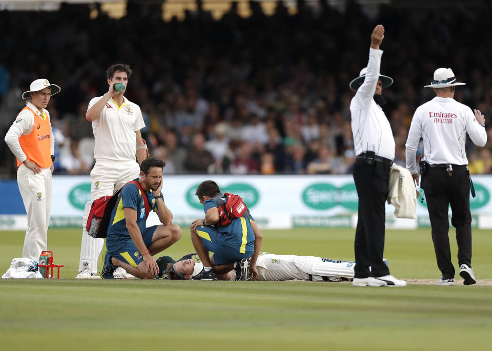 Smith is assessed by Australian Team Doctor after he was struck by a delivery from Jofra Archer. (Photo by Ryan Pierse/Getty Images)