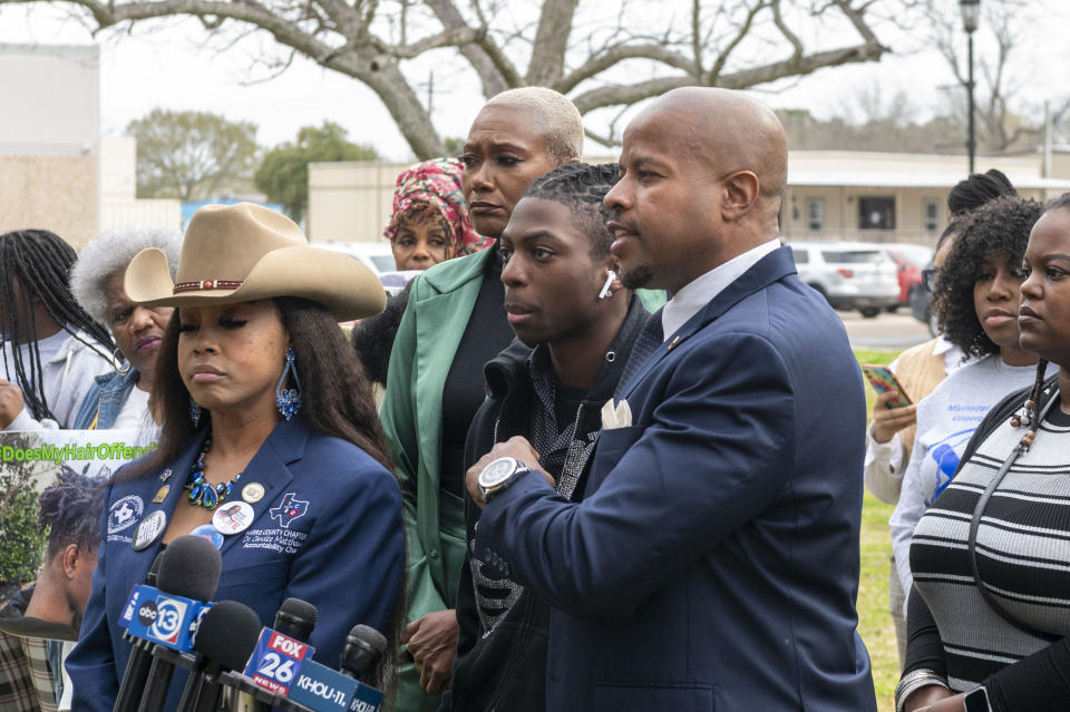 Dr. Candice Matthews, left, and state representative Jolanda Jones, inside left, stand with Darryl George, center, listens as state representative Ron Reynolds, right center, comments during a press conference before a hearing regarding George's punishment for violating school dress code policy because of his hair style, Thursday Feb. 22, 2024 at the Chambers County Courthouse in Anahuac, Texas. A judge has ruled that George's monthslong punishment by his Texas school district for refusing to change his hairstyle does not violate a new state law prohibiting race-based hair discrimination. (Kirk Sides/Houston Chronicle via AP)