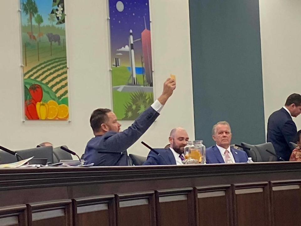 Sen. Aaron Bean, a Republican and an auctioneer from Jacksonville, holds up a slip of paper in blind draw to assign odd or even numbers to Senate districts on the new map being considered, on Thursday, Jan. 13, 2022, at the Florida Capitol in Tallahassee