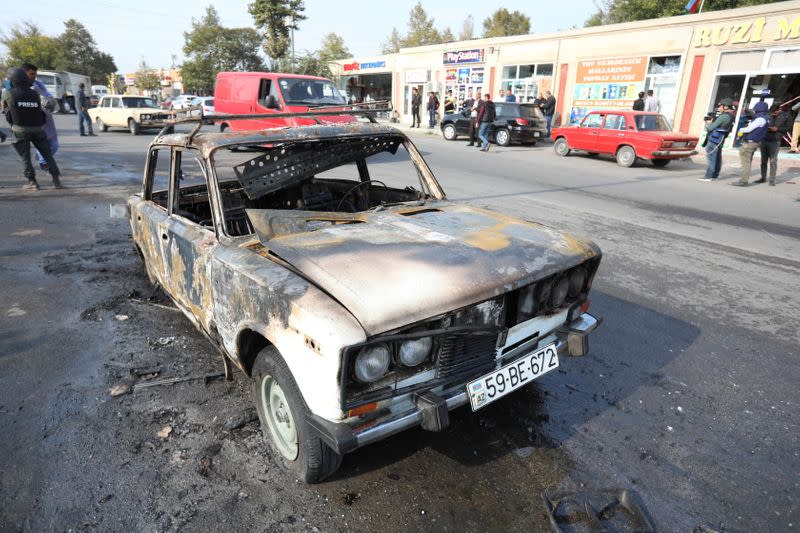 A view shows a burnt car hit by shelling in Barda