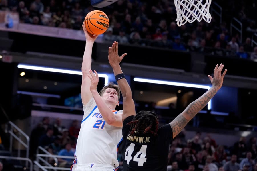 Florida forward Alex Condon (21) shoots over Colorado center Eddie Lampkin Jr. (44) in the first half of a first-round college basketball game in the NCAA Tournament, Friday, March 22, 2024, in Indianapolis, Ind. (AP Photo/Michael Conroy)