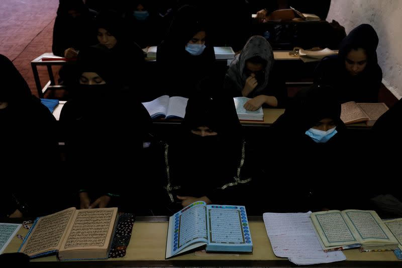 Afghan women learn how to read the Koran in a madrasa or religious school in Kabul