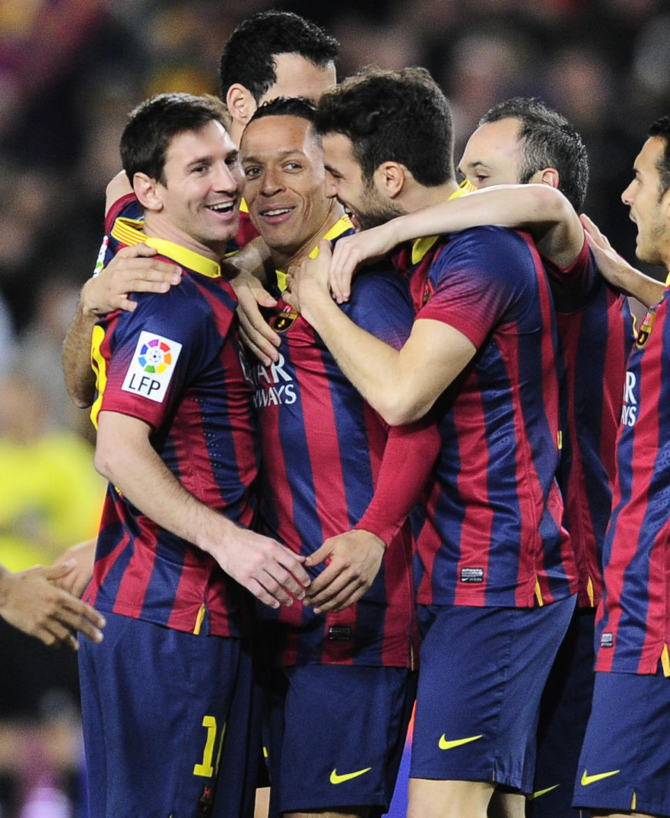FC Barcelona's Adriano, from Brazil, second left, reacts after scoring with his teammates Lionel Messi, from Artentina, left, and Cesc Fabregas, third left, against Rayo Vallecano during a Spanish La Liga soccer match at the Camp Nou stadium in Barcelona, Spain, Saturday, Feb. 15, 2014. (AP Photo/Manu Fernandez)