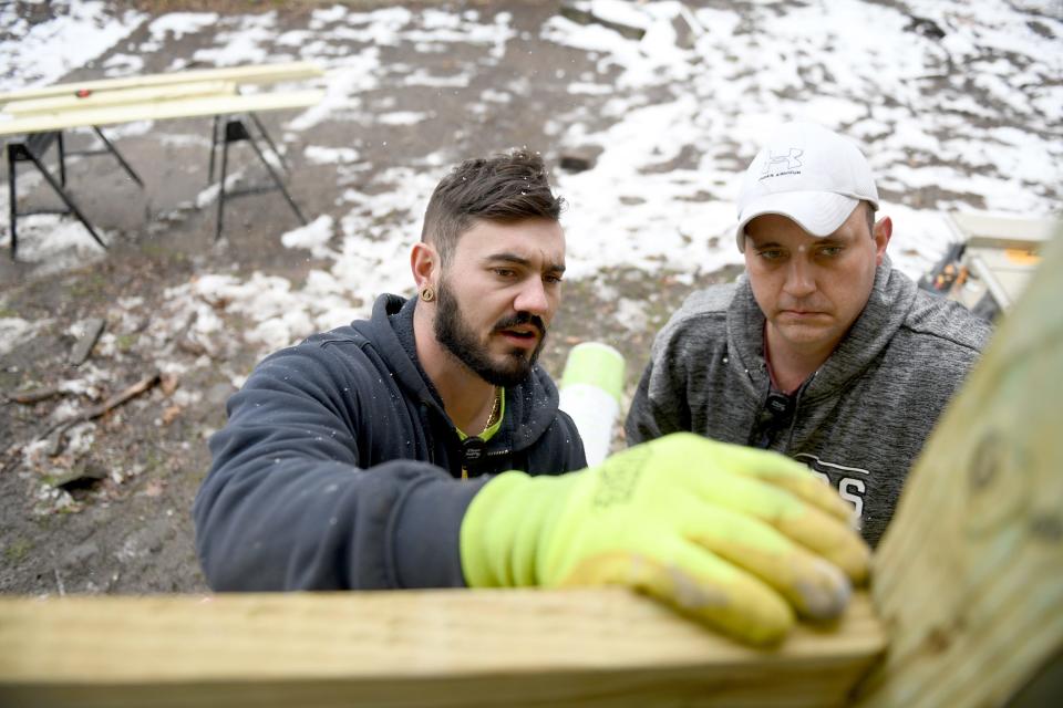 Mike Varn, left, and Reid Carnes with Canton For All People, work to refurbish a home on Ninth Street NW as work continues in coordination with the city to revitalize the greater Shorb area.