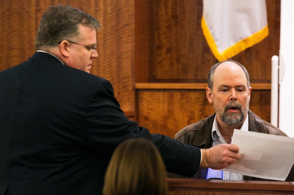 Home electronics contractor Mark Archambault (R) reviews an exhibit with Assistant District Attorney Roger L. Michel Jr. during the murder trial for former NFL player Aaron Hernandez at the Bristol County Superior Court in Fall River, Massachusetts, February 17, 2015. REUTERS/Dominick Reuter (UNITED STATES - Tags: CRIME LAW)