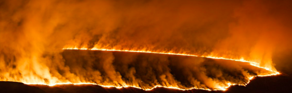 <em>Witnesses described the ‘terrible’ scene of fire coming close to buildings high on the moorland (Twitter/@RJNeedhamphoto/PA)</em>