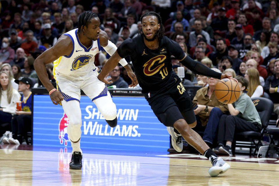 Cleveland Cavaliers guard Darius Garland (10) drives against Golden State Warriors forward Jonathan Kuminga, left, during the first half of an NBA basketball game, Sunday, Nov. 5, 2023, in Cleveland. (AP Photo/Ron Schwane)