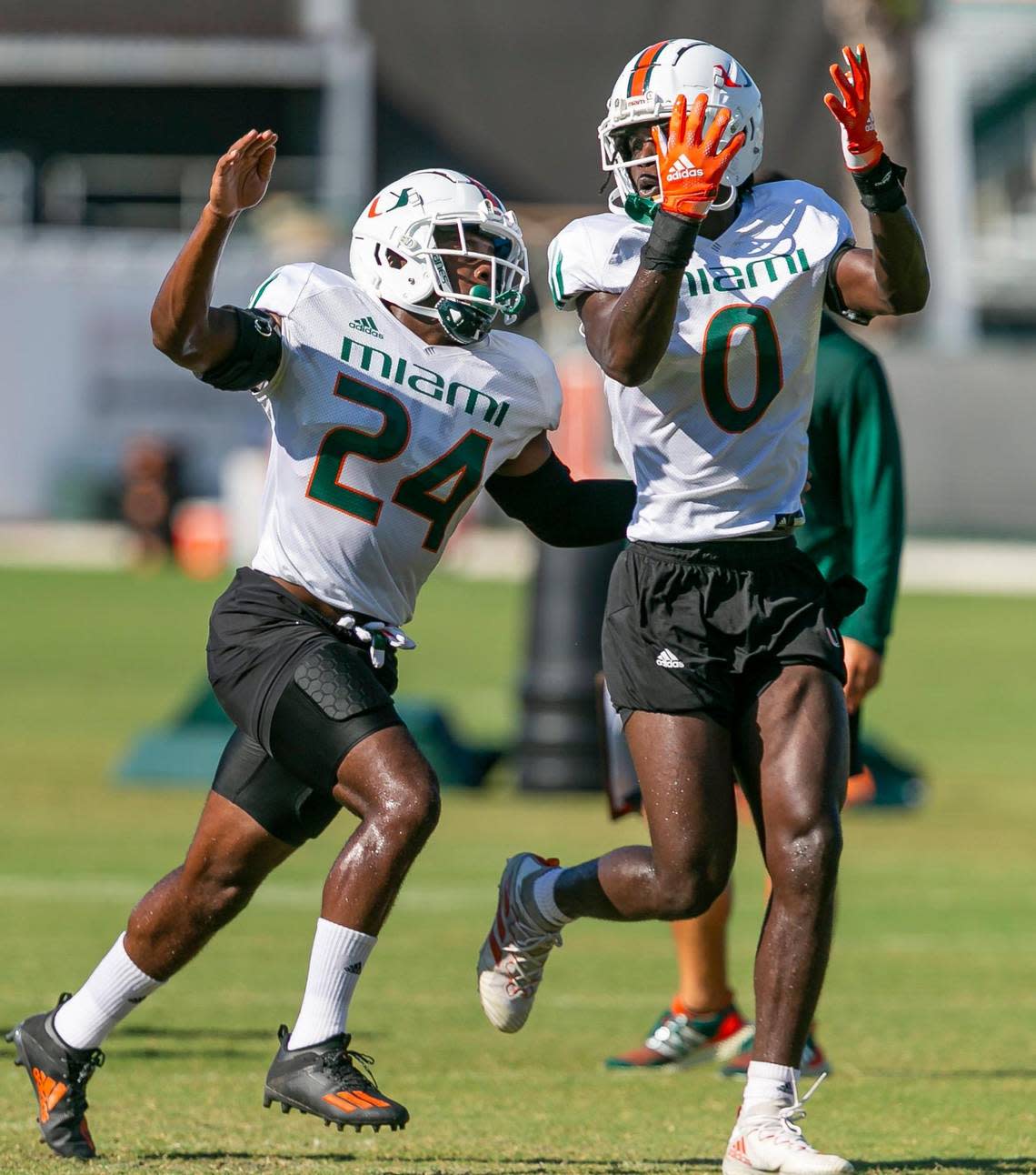 Miami Hurricanes defensive backs Kamren Kinchens (24) and James Williams (0) run drills at the University of Miami’s Greentree Practice Fields on Monday, Aug. 15, 2022, in Coral Gables, Fla.