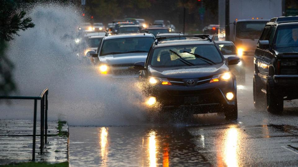 PHOTO: Drivers navigate a lane filled with rain water in Eugene, Oregon as an atmospheric river moves through the Willamette Valley during the winter of 2023. (Chris Pietsch/The Register Guard via USA Today Network)