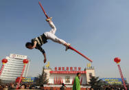 A local resident on stilts jumps during a performance to celebrate the Lantern Festival at a square in Changzhi, Shanxi province February 21, 2008. The last day of the Chinese New Year, known as the Lantern Festival, is celebrated today. REUTERS/Stringer