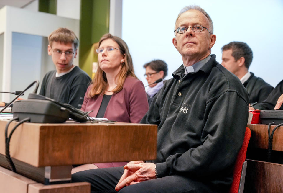 FILE - Priest Joerg Alt, right, looks on at the beginning of his trial at a court in Munich, Germany, Wednesday, May 3, 2023. A German court on Tuesday convicted a Jesuit priest of coercion in connection with a climate protest last year and ordered him to pay a small fine. In Alt's case, that was a 10-euro ($10.85) fine. (AP Photo/Matthias Schrader, File)