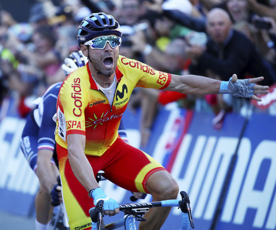 Spain's Alejandro Valverde crosses the finish line to win the men's road race at the Road Cycling World Championships in Innsbruck, Austria, Sunday, Sept.30, 2018. (AP Photo/Alessandro Trovati)