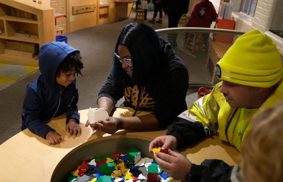 Savior Perez, 4,  plays with his mom, Janay Wilcox, and his dad, Daniel Perez, at the Providence Children's Museum on Tuesday evening.