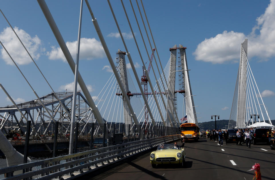 New York Governor Andrew Cuomo drives a 1955 Chevrolet Corvette with World War II veteran Armando "Chick" Gallela, during a dedication ceremony for the new Governor Mario M. Cuomo Bridge that is to replace the current Tappan Zee Bridge over the Hudson River in Tarrytown, New York, U.S., August 24, 2017. REUTERS/Mike Segar