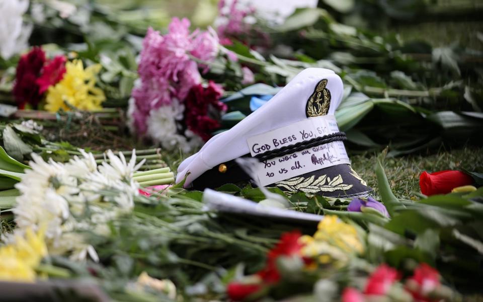  A captain's cap with message of condolence on flowers left outside of Windsor Castle on April 11, 2021 in Windsor, England