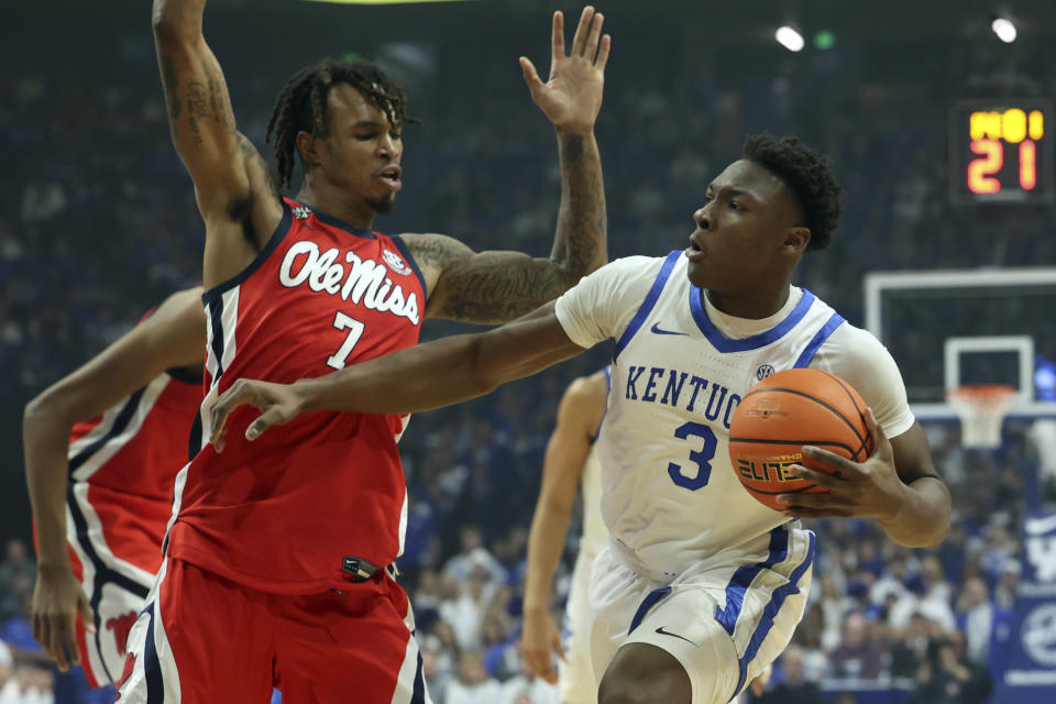 Kentucky's Adou Thiero (3) looks for an opening on Mississippi's Allen Flanigan (7) during the first half of an NCAA college basketball game Tuesday, Feb. 13, 2024, in Lexington, Ky. (AP Photo/James Crisp)