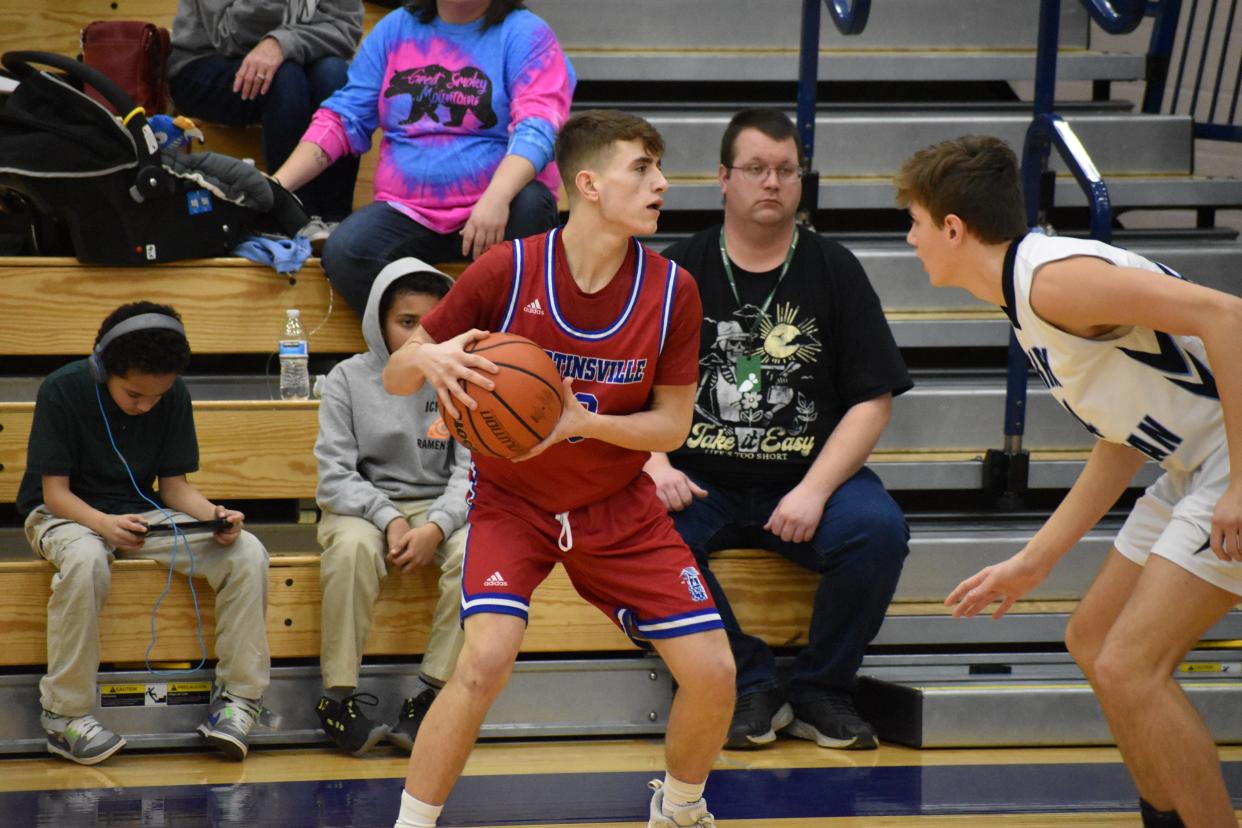 Martinsville guard Isaiah Marlett looks for a pass as a Perry Meridian player defends during their matchup on Jan. 21, 2022.