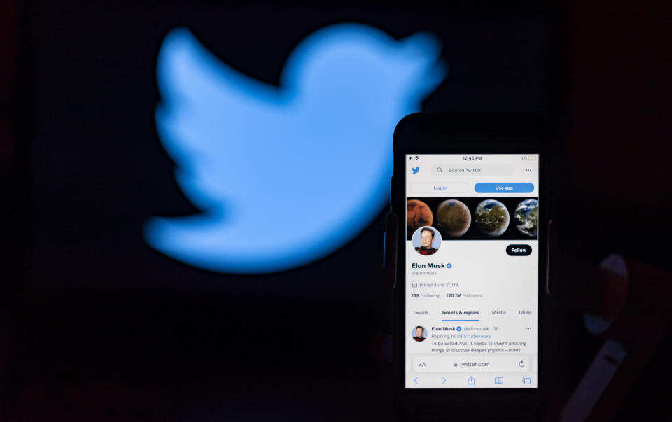 INDIA - 2022/12/07: In the photo illustration, Elon Musk's twitter account is seen displayed on a mobile phone screen with the twitter logo on the background. (Photo Illustration by Idrees Abbas/SOPA Images/LightRocket via Getty Images)
