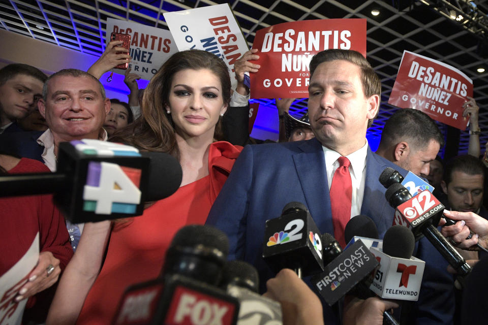 CORRECTS SPELLING TO FRUMAN, NOT FURMAN FILE- In this Nov. 6, 2018 file photo, Florida Governor-elect Ron DeSantis, right, answers questions from reporters, with his wife Casey, after being declared the winner of the Florida gubernatorial race at an election party, in Orlando, Fla. Standing behind Casey DeSantis is Lev Parnas. Parnas and his associate Igor Fruman are facing federal charges in connection to efforts by President Donald Trump's lawyer, Rudy Giuliani, to launch a Ukrainian corruption investigation against Joe Biden and his son, Hunter. (AP Photo/Phelan M. Ebenhack, File)