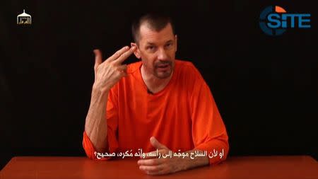 A still image taken from a purported Islamic State video released September 18, 2014 by the SITE Intel Group shows British captive John Cantlie making a statement. Islamic State militants fighting in Iraq and Syria released a video on Thursday that they said shows British journalist John Cantlie in captivity saying he will soon reveal "facts" about the group to counter its portrayal in Western media. The Islamic State, which controls territory in Syria and Iraq, has already beheaded two American journalists and one British aid worker in recent weeks in what it said was reprisal for U.S. air strikes against it in Iraq. REUTERS/SITE Intel Group via Reuters TV (SYRIA - Tags: POLITICS CRIME LAW) NO SALES. NO ARCHIVES. FOR EDITORIAL USE ONLY. NOT FOR SALE FOR MARKETING OR ADVERTISING CAMPAIGNS. THIS IMAGE HAS BEEN SUPPLIED BY A THIRD PARTY. IT IS DISTRIBUTED, EXACTLY AS RECEIVED BY REUTERS, AS A SERVICE TO CLIENTS. MANDATORY CREDIT