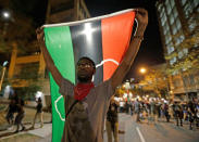 <p>A protester holds a flag as he marches in the streets of Charlotte, N.C. Friday, Sept. 23, 2016 over Tuesday’s fatal police shooting of Keith Lamont Scott. (AP Photo/Chuck Burton)</p>