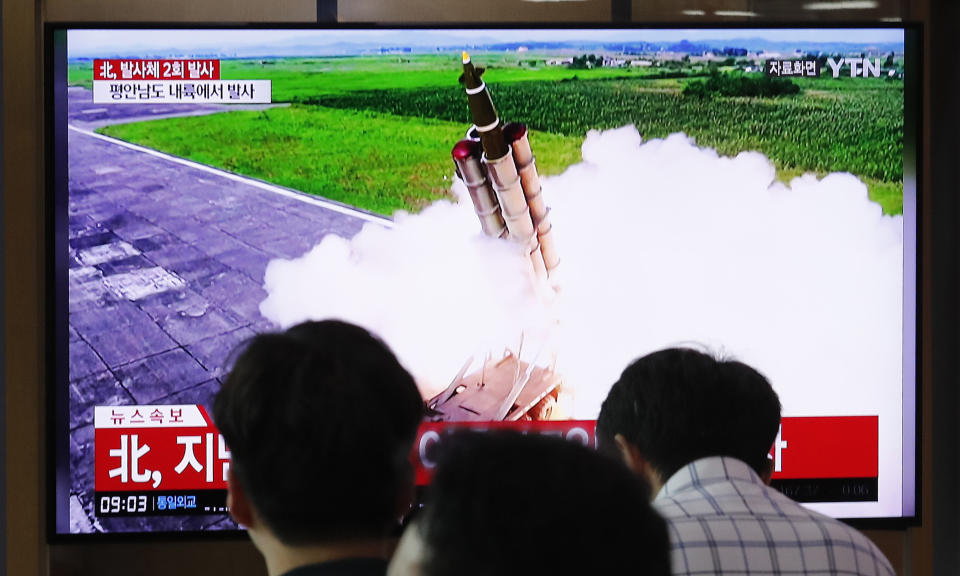 People watch a TV showing a file image of an unspecified North Korea's missile launch during a news program at the Seoul Railway Station in Seoul, South Korea, Tuesday, Sept. 10, 2019. North Korea launched at least two unidentified projectiles toward the sea on Tuesday, South Korea's military said, hours after the North offered to resume nuclear diplomacy with the United States but warned its dealings with Washington may end without new U.S. proposals. The sign reads " North Korea launched at least two unidentified projectiles." (AP Photo/Ahn Young-joon)