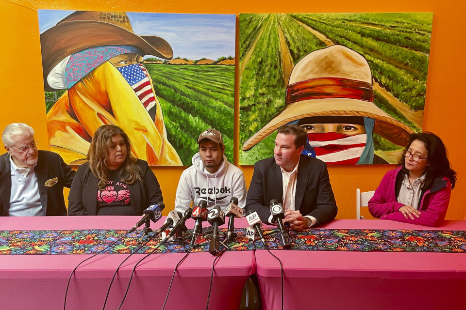 Pedro Romero Perez, center, sits next to his attorney Donald Magilligan, second from right, during a press conference Friday, April 5, 2024, in Half Moon Bay, Calif. Perez, a migrant farmworker who survived a mass shooting at a Northern California mushroom farm, filed a lawsuit Friday against the farm owner, saying he failed to keep him safe from a co-worker who last year shot and killed his brother and three other co-workers before driving to another mushroom farm and killing three former colleagues. (AP Photo/Haven Daley)