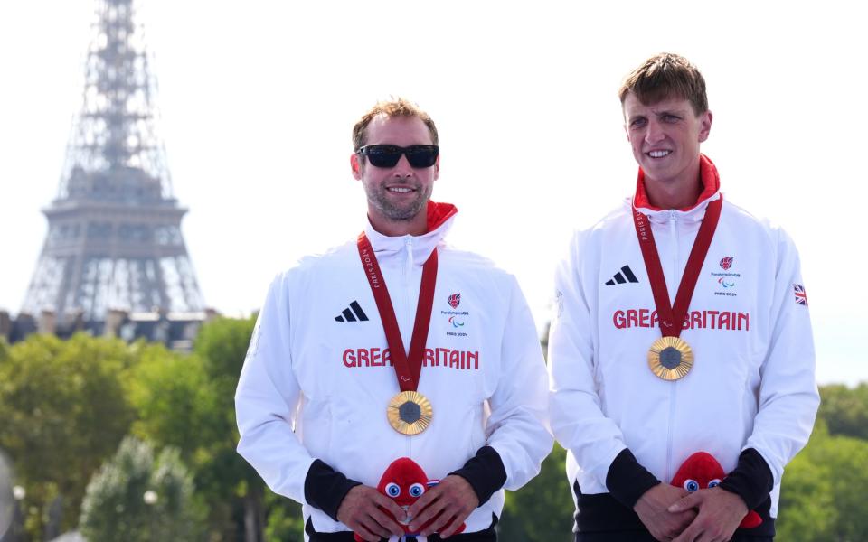 Dave Ellis (left) and guide Luke Pollard on the podium with their gold medals