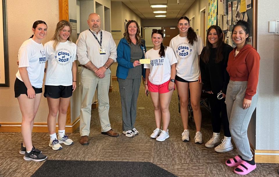 Members of the Horseheads and Thomas A. Edison softball teams present a check to the Falck Cancer Center with proceeds raised by the teams with their Strike Out Cancer game May 6, 2023.