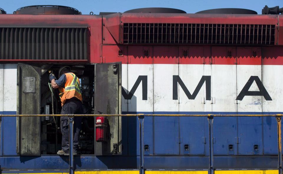 An engineer checks the engine of a Montreal Maine & Atlantic locomotive outside the offices of MMA railway in the town of Farnham, Que., on July 11, 2013, a few days after the disaster. THE CANADIAN PRESS/Graham Hughes