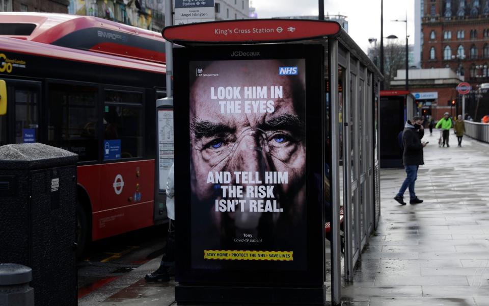 A coronavirus information sign on a London bus stop - AP