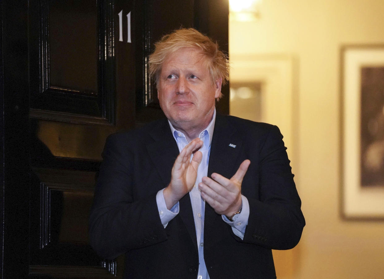 In this handout photo provided by 10 Downing Street, Britain's Prime Minister Boris Johnson claps outside 11 Downing Street to salute local heroes during Thursday's nationwide Clap for Carers NHS initiative to applaud workers fighting the coronavirus pandemic, in London, Thursday, April 2, 2020. The new coronavirus causes mild or moderate symptoms for most people, but for some, especially older adults and people with existing health problems, it can cause more severe illness or death. (Pippa Fowles/The new coronavirus causes mild or moderate symptoms for most people, but for some, especially older adults and people with existing health problems, it can cause more severe illness or death.The new coronavirus causes mild or moderate symptoms for most people, but for some, especially older adults and people with existing health problems, it can cause more severe illness or death.(Pippa Fowles/10 Downing Street via AP)