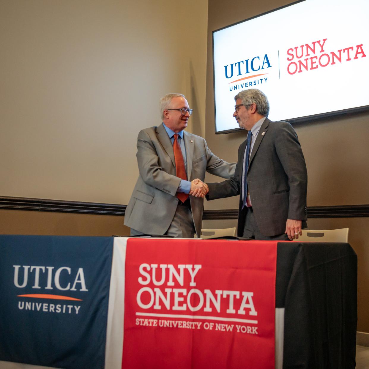 President of Utica University Todd Pfannestiel and President of SUNY Oneonta Alberto Cardelle shake hands after signing an articulation agreement for nursing students on Wednesday, January 24, 2024.